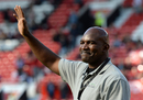 Evander Holyfield waves to the crowd before kick-off