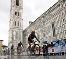 Cyclists ride past the Santa Maria del Fiore Basilica