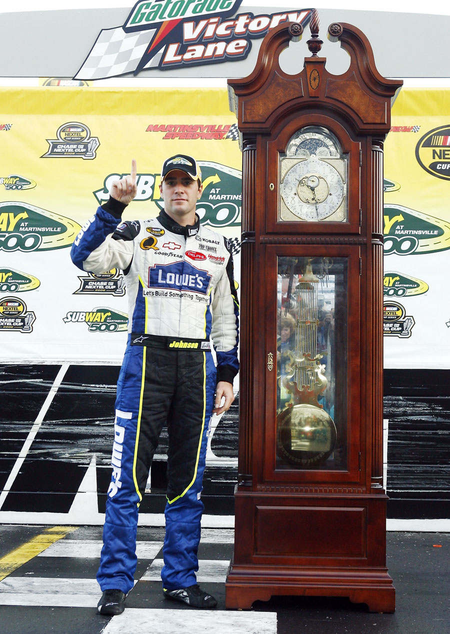 Lowe's Chevrolet's Jimmie Johnson poses with the grandfather clock trophy