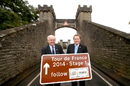 Councillor John Weighall and Gary Verity hold a road sign for the Tour de France