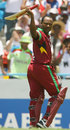 Brian Lara salutes the crowd as he walks off for the final time