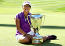 Lydia Ko poses with her trophy following her five-stroke victory