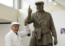 Dickie Bird stands next to his statue