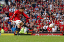 Ruud van Nistelrooy thumps his penalty against the bar