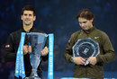 Novak Djokovic lifts the trophy as Rafael Nadal looks dejected