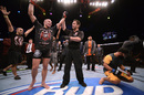 Georges St-Pierre celebrates UFC 167 victory over a distraught Johny Hendricks