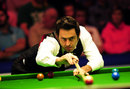 Ronnie O'Sullivan plays a shot with the rest