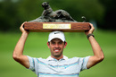 Charl Schwartzel holds the trophy aloft after winning the Alfred Dunhill Championship for a third time