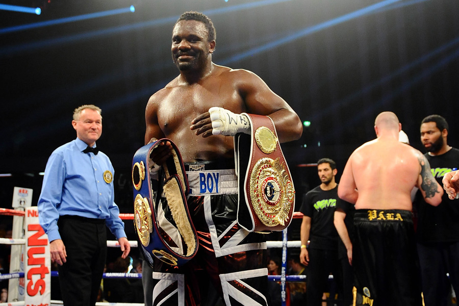 Dereck Chisora stands with his belts