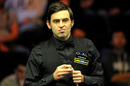 Ronnie O'Sullivan chalks his cue during his round three match with Marcus Campbell