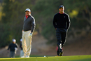 Tiger Woods and Graeme McDowell walk to the 18th green