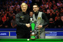 Neil Robertson and Mark Selby shake hands in front of the UK Championship trophy prior to their final