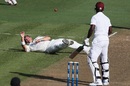 Corey Anderson falls over after being hit by the ball