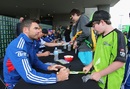 James Anderson signs a bat for a fan