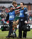 Leicester's Tom Croft is helped off after injuring his knee