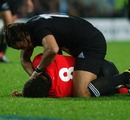 Colin Charvis is rolled into the recovery position by Tana Umaga