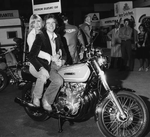 Barry Sheene and his girlfriend sit on his Suzuki GS750 four-stroke