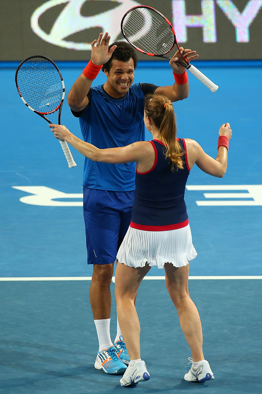 Alize Cornet and Jo-Wilfried Tsonga celebrate defeating Petra Kvitova and Radek Stepanek in the mixed doubles