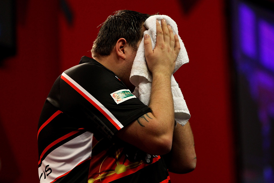 Adrian Lewis buries his head in a towel after semi-final defeat to Michael van Gerwen