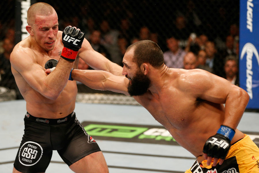 Johny Hendricks lands a punch on Georges St-Pierre