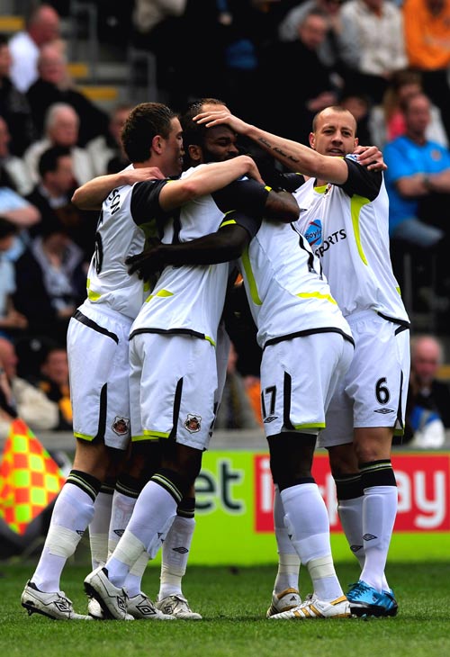 Darren Bent is mobbed by his team-mates after scoring