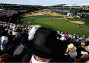 Fans watch on at the famous Stadium Hole as Phil Mickelson makes a putt