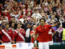 Roger Federer celebrates a winning return for Switzerland
