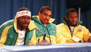 Jamaica's bobsled team member Freddie Powell speaks during a press conference as his teammates Michael White and Allen Caswell listen
