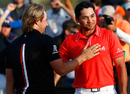Jason Day is congratulated by Victor Dubuisson after winning the championship match on the 23rd hole