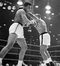 Cassius Clay ducks a right hook from Sonny Liston