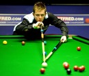 Mark Allen leans over the table