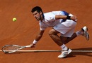 Novak Djokovic stoops to reach a return