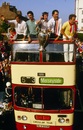 Liverpool players parade the European cup trophy from on top of an open bus for a victory parade through the city 