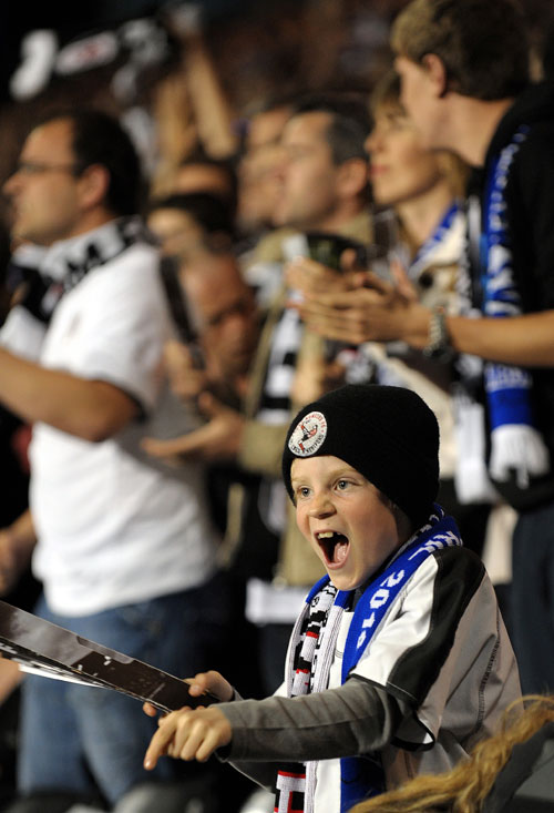 A young Fulham fan celebrates his team's progress to the Europa League final