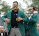 Phil Mickelson receives the green jacket from 2003 Champion Mike Weir after winning the Masters