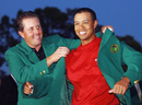 Tiger Woods is awarded his green jacket by 2004 champion Phil Mickelson