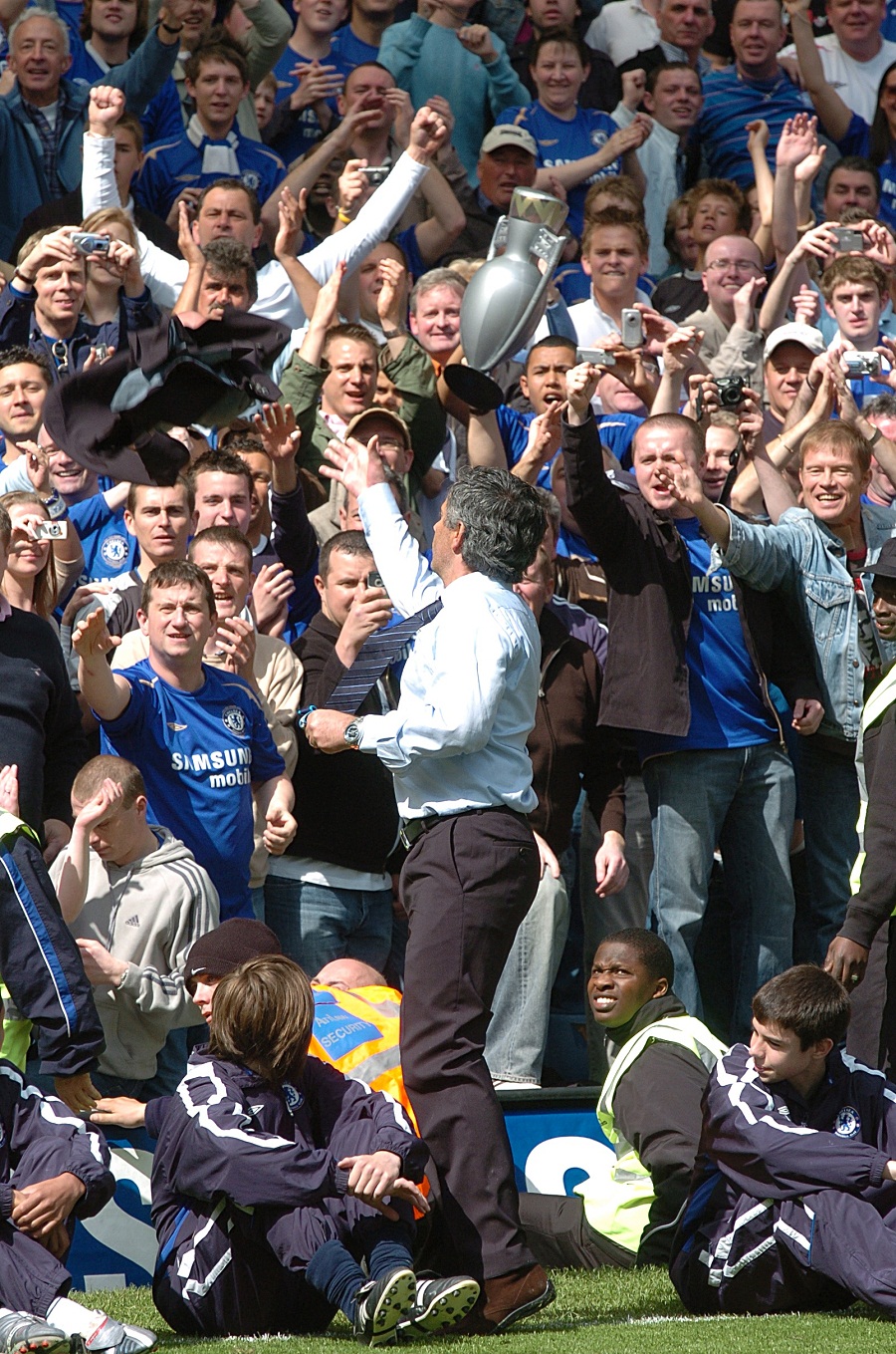 Jose Mourinho throws his medal into the crowd