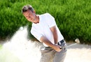 Mark Foster takes sand and ball as he clears a bunker