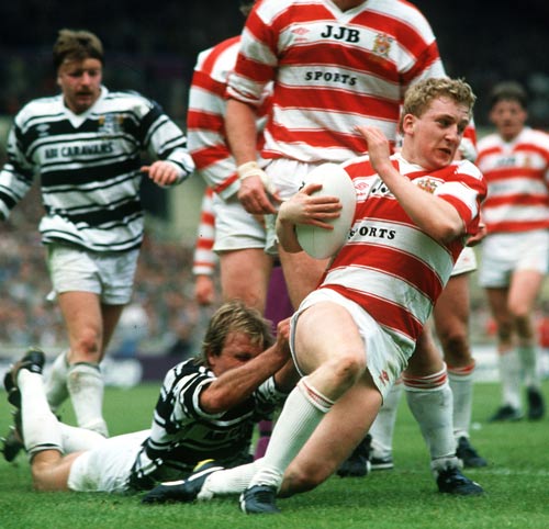 Shaun Edwards is tackled by Peter Sterling 