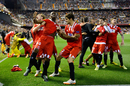 Stephane Mbia is mobbed by his Sevilla team-mates