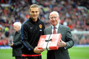 Nemanja Vidic is presented with a gift by Sir Bobby Charlton