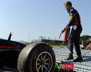 Sebastian Vettel goes to work on his Red Bull after suffering an electrical issue