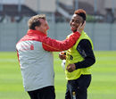 Brendan Rodgers shares a joke with Raheem Sterling during Liverpool training