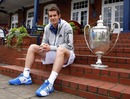 Defending champion Andy Murray shows off his trophy