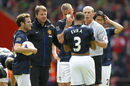 Patrice Evra chats with referee Mike Dean