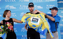 Bradley Wiggins is helped into the yellow jersey after retaining his lead in the Tour of California