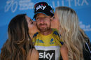 Bradley Wiggins is given a kiss as he is presented with the yellow jersey after stage five