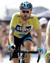 Bradley Wiggins smiles as he crosses the line at the end of stage six