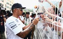 Lewis Hamilton signs autographs for the fans