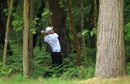 Sergio Garcia plays his second shot out of the trees on the 12th hole